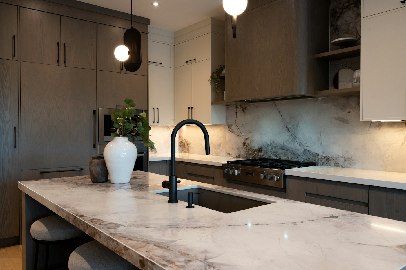 Marble kitchen island with black tapware