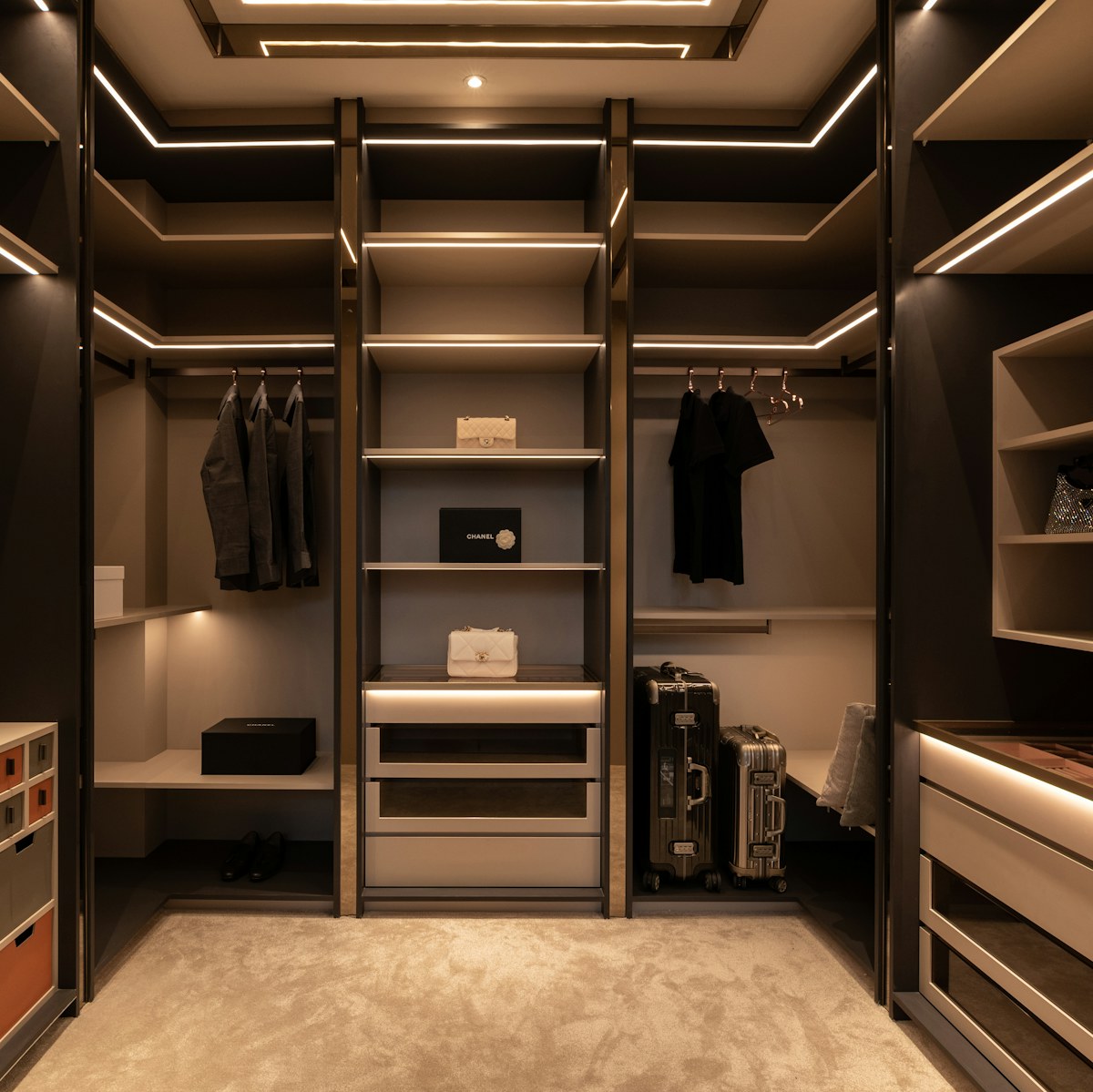 Smoked walnut walk-in closet with LED-lit rails